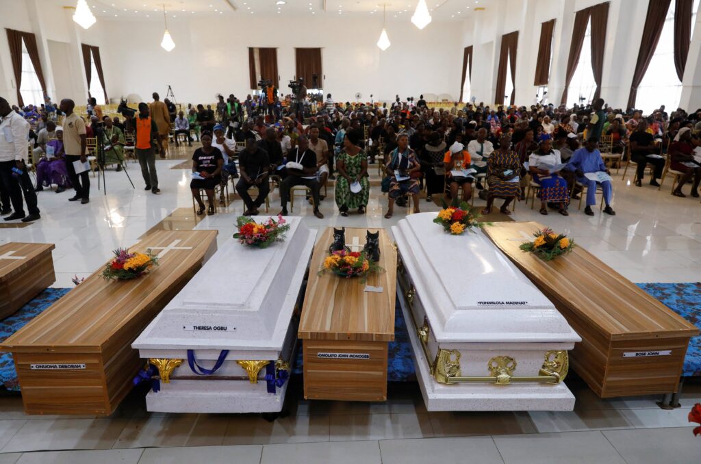 Caskets are pictured during a funeral service in the parish hall of St. Francis Xavier Church in Owo, Nigeria, June 17, 2022. The service was for at least 50 victims killed in a June 5 attack by gunmen during Mass at the church.