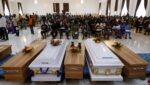 Caskets are pictured during a funeral service in the parish hall of St. Francis Xavier Church in Owo, Nigeria, June 17, 2022. The service was for at least 50 victims killed in a June 5 attack by gunmen during Mass at the church.