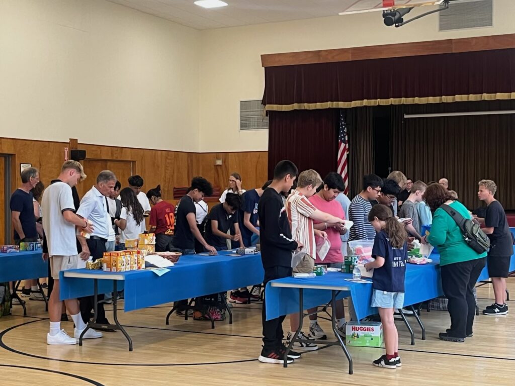 Youths, retreat staff and volunteers pack food and essentials for charity during the Summer 2025 Teen Retreat at St. Mary’s Parish in Wappingers Falls. The 2026 Teen Retreat will be held August 22 at St. Kateri Tekakwitha Church in LaGrangeville.