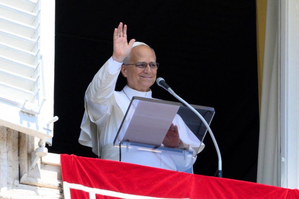 Pope Leo XIV gestures as he leads the weekly Angelus prayer from a window at the Vatican, August 9, 2026.