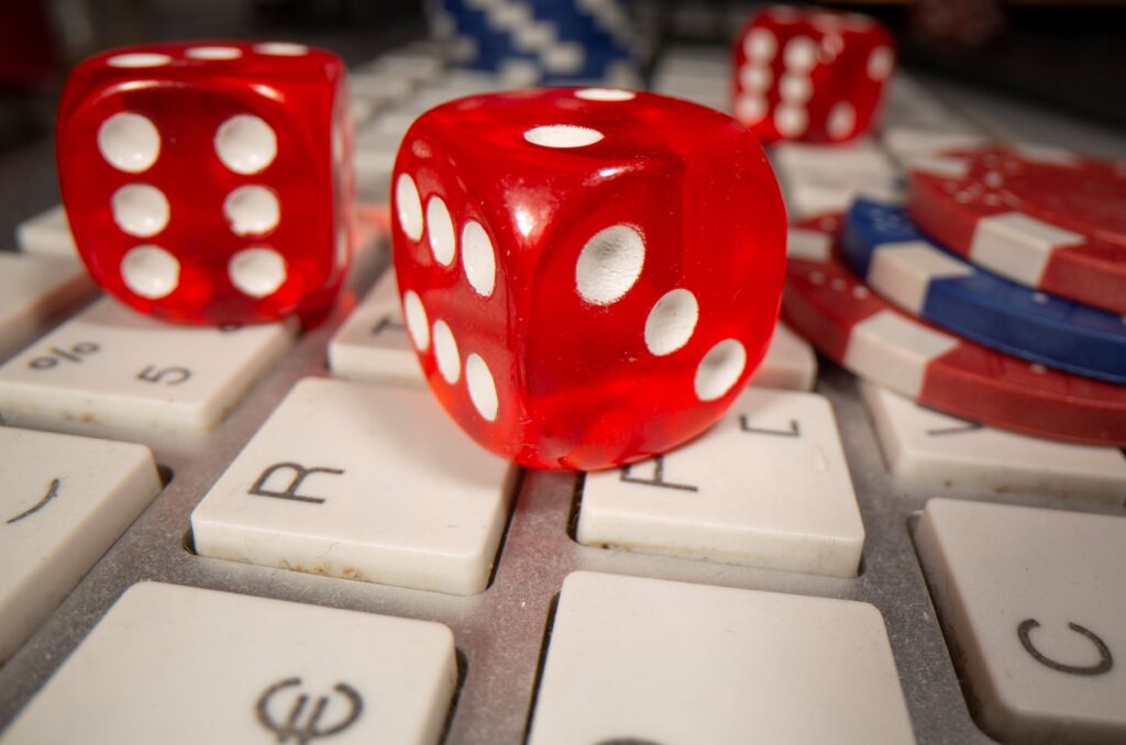 Gambling dice and chips are seen on the keyboard in this illustration, June 5, 2020.