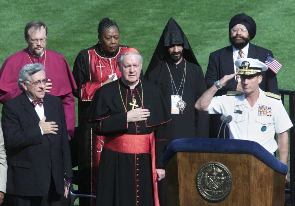 Representatives of several religious communities, including Rabbi Marc Gellman, left, Cardinal Edward M. Egan, center, join Adm. Robert Natter, right, at the interfaith prayer service at Yankee Stadium in the Bronx on Sept. 23, 2001. The terrorists "picked the wrong city ... and country," said Natter to the thousands of New Yorkers who prayed for the victims of the World Trade Center tragedy.