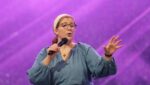 Emcee Katie Prejean McGrady speaks during a July 19, 2024, impact session at Lucas Oil Stadium during the National Eucharistic Congress in Indianapolis.