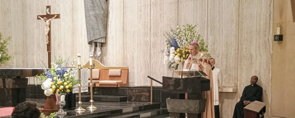 Archbishop Ronald Hicks (standing, right) speaks during the annual United Nations Prayer Service at Holy Family Church, East 47th Street, Manhattan, on Tuesday, September 8, 2026.