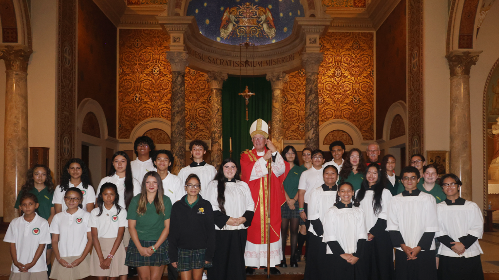 Cardinal Dolan poses with students from Sacred Heart after celebrating the Mass of the Holy Spirit.