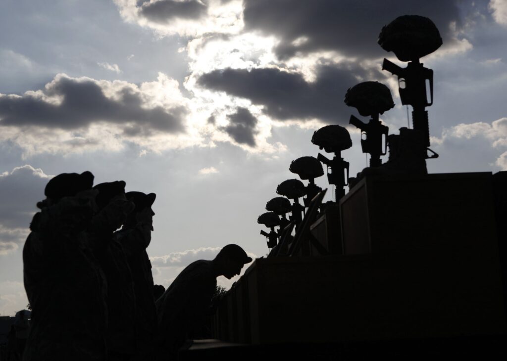 U.S. soldiers pay their respects in front of fallen soldier memorials following a memorial ceremony held at Fort Hood, Texas, on Nov. 10, 2009, for victims of the Nov. 5, 2009, shooting at the Fort Hood Army post.