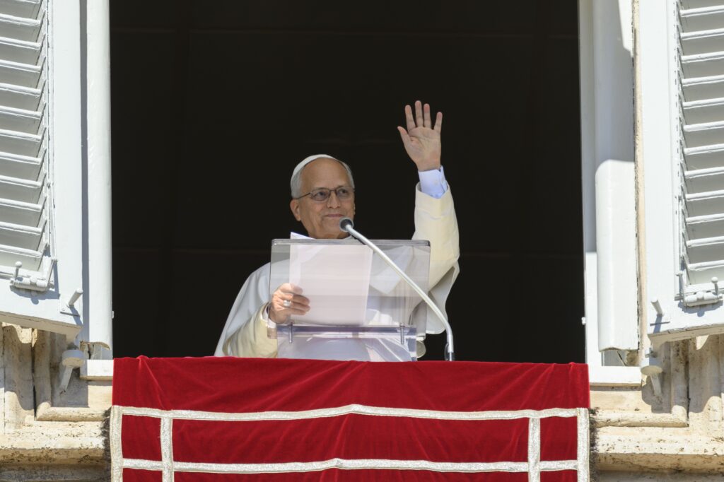 Pope Leo XIV waves as he leads the Angelus prayer in St. Peter's Square at the Vatican on Oct. 11, 2026.