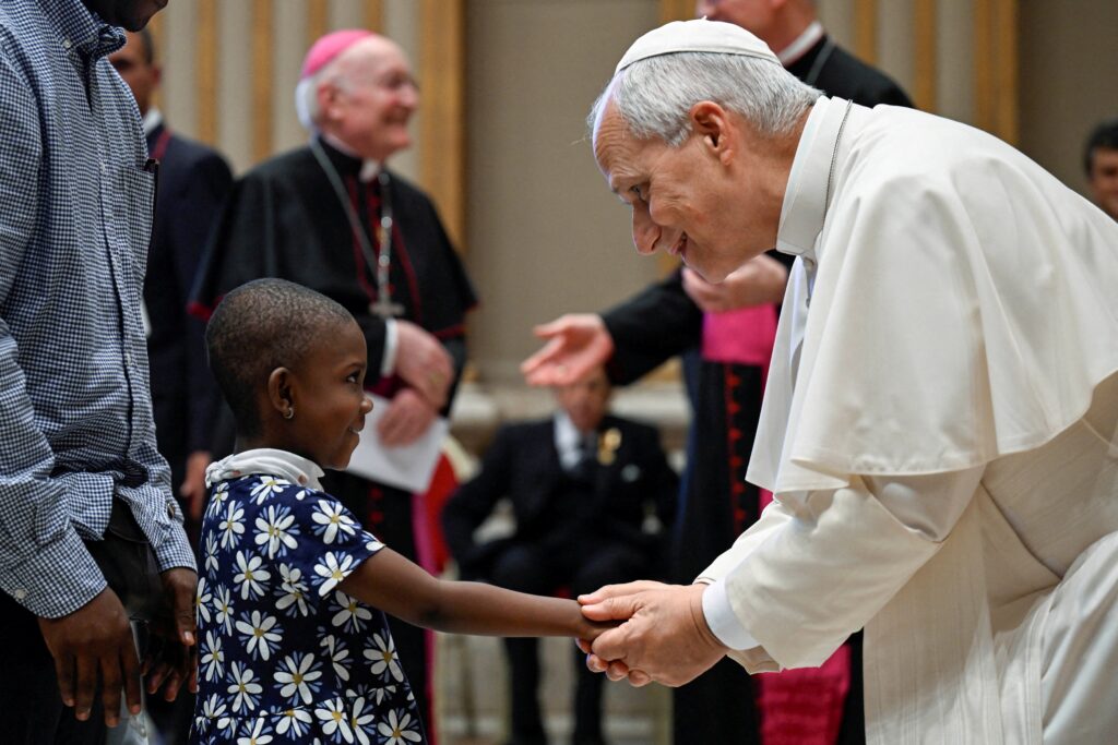 Pope Leo XIV greets a child during a meeting with members and volunteers of the Circolo San Pietro at the Vatican Oct. 12, 2026. Political and religious leaders worldwide offered prayers and support for Pope Leo after he announced Oct. 11 that he will undergo surgery to remove a small, localized lung nodule detected by doctors.