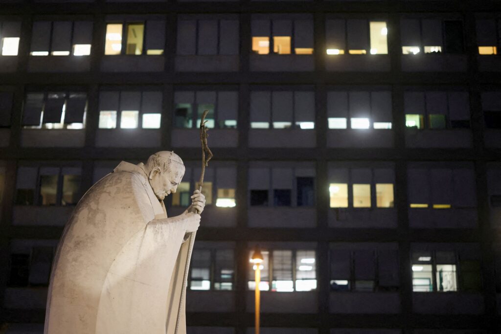 A statue of the St. John Paul II is seen outside Gemelli Hospital in Rome Oct. 13, 2026, where Pope Leo XIV had surgery that afternoon to remove a lung nodule. The Vatican confirmed that evening that Pope Leo has lung cancer.