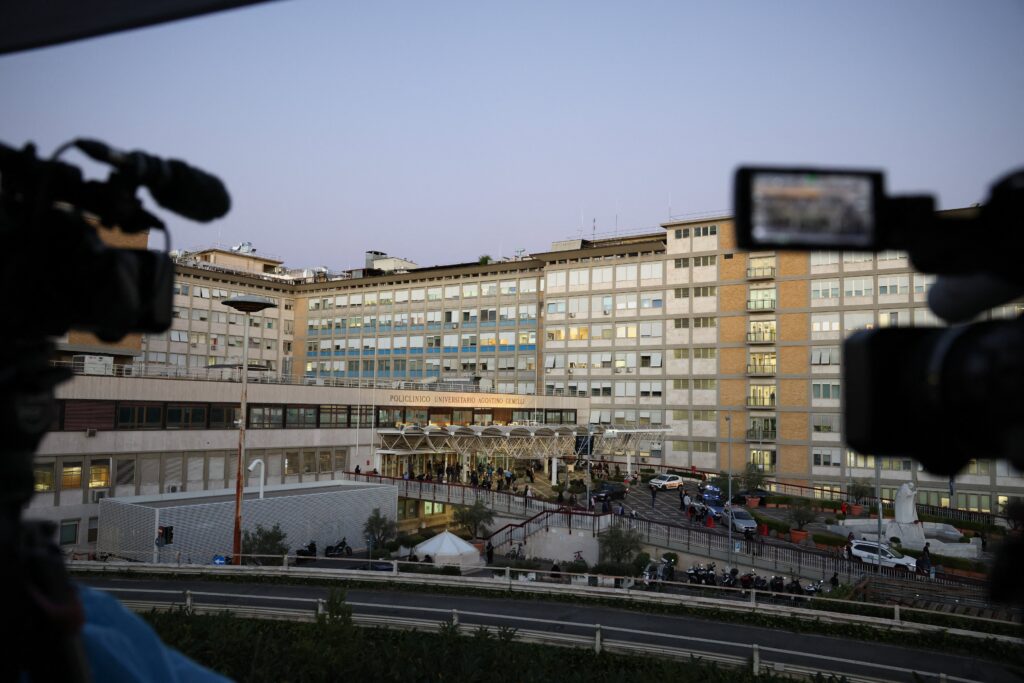 Cameras are setup outside Rome's Gemelli Hospital in the evening hours of Oct. 13, 2026, where Pope Leo XIV underwent surgery to remove a lung nodule. The Vatican announced that evening the surgery was successful, but revealed the pope was confirmed to have lung cancer.