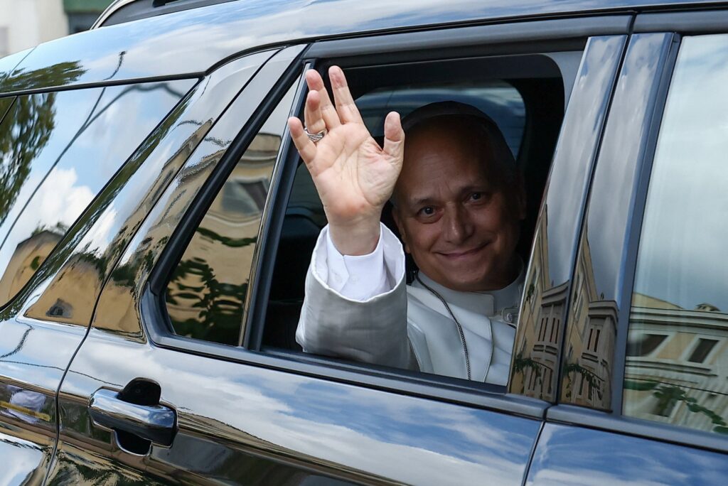 Pope Leo XIV waves from a car as he returns to the Vatican from Gemelli Hospital following his lung surgery and cancer diagnosis, at the Porta del Perugino, in Rome, Oct. 17, 2026. Photo: OSV News/Guglielmo Mangiapane, Reuters