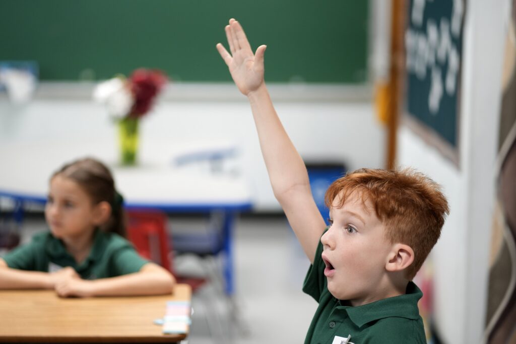 A student raises his hand to answer a question on the first day of the 2026-27 academic year at St. Patrick School in Smithtown, Sept. 3, 2026.