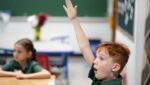 A student raises his hand to answer a question on the first day of the 2026-27 academic year at St. Patrick School in Smithtown, Sept. 3, 2026.
