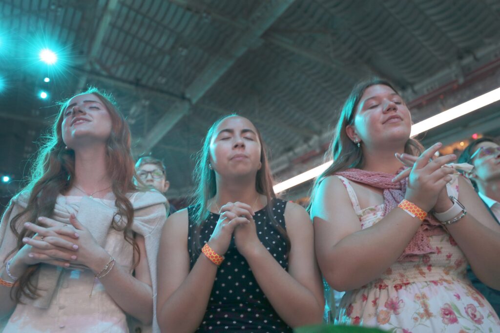 Young women pray while listening to Catholic musician Matt Maher perform ahead of the beatification Mass for Archbishop Fulton J. Sheen Sept. 24, 2026, at The Dome at America's Center in St. Louis. Blessed Fulton J. Sheen is remembered as one of the most influential and innovative evangelists in American history.
