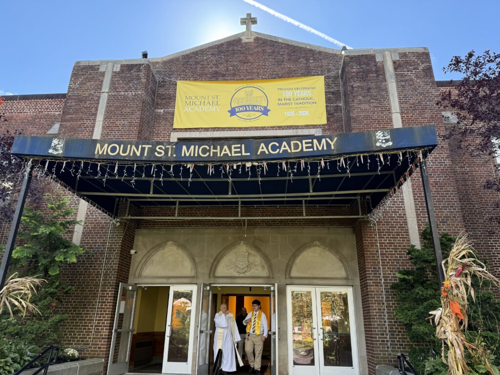 Msgr. Joseph LaMorte (bottom, left) points to his childhood home from the door of Mount Saint Michael Academy in the Wakefield section of the Bronx, Sept. 29, 2026.