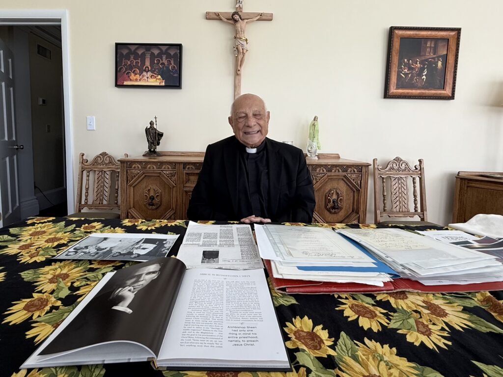 Msgr. Hilary Franco poses with some of his second-class relics of Blessed Fulton Sheen, with whom he worked directly for seven years and remained friends until Sheen’s death in 1979.
