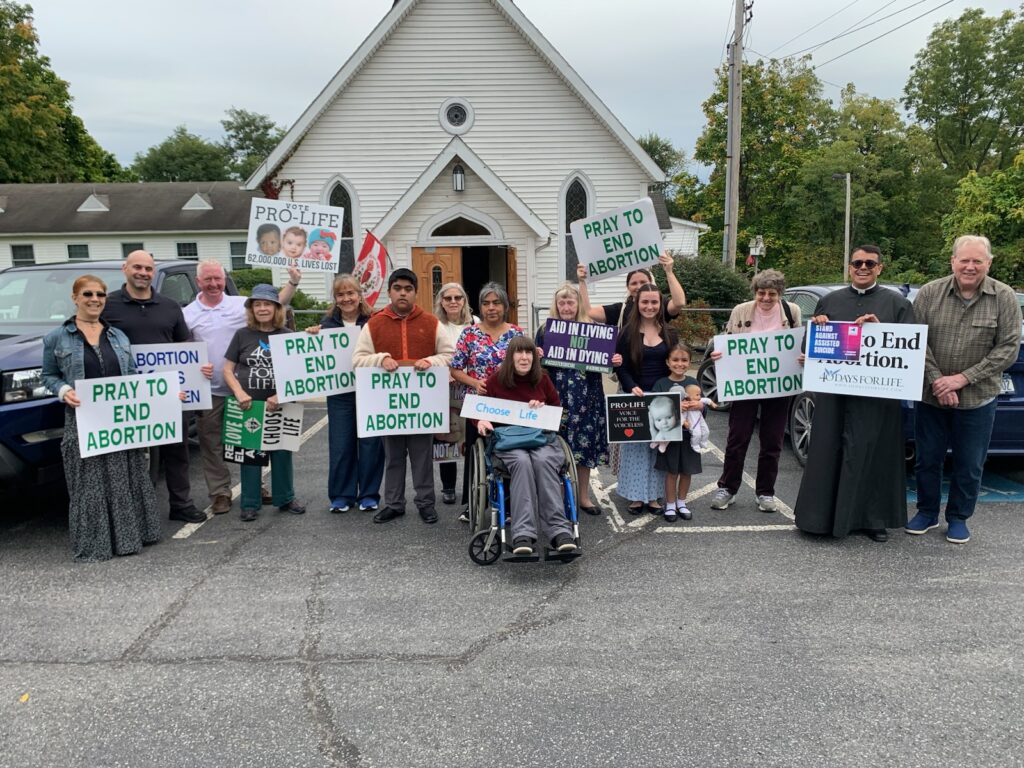 Parishioners of St. Mary-Sacred Heart hold signs opposing abortion and euthanasia in front of Sacred Heart Church in Esopus on Respect Life Sunday, Oct. 4, 2026.