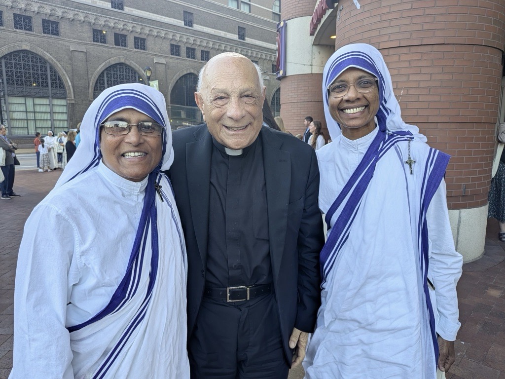 Msgr. Hilary Franco (center) stands with two Sisters of Charity outside The Dome at America's Center in St. Louis on Sept. 24, 2026.