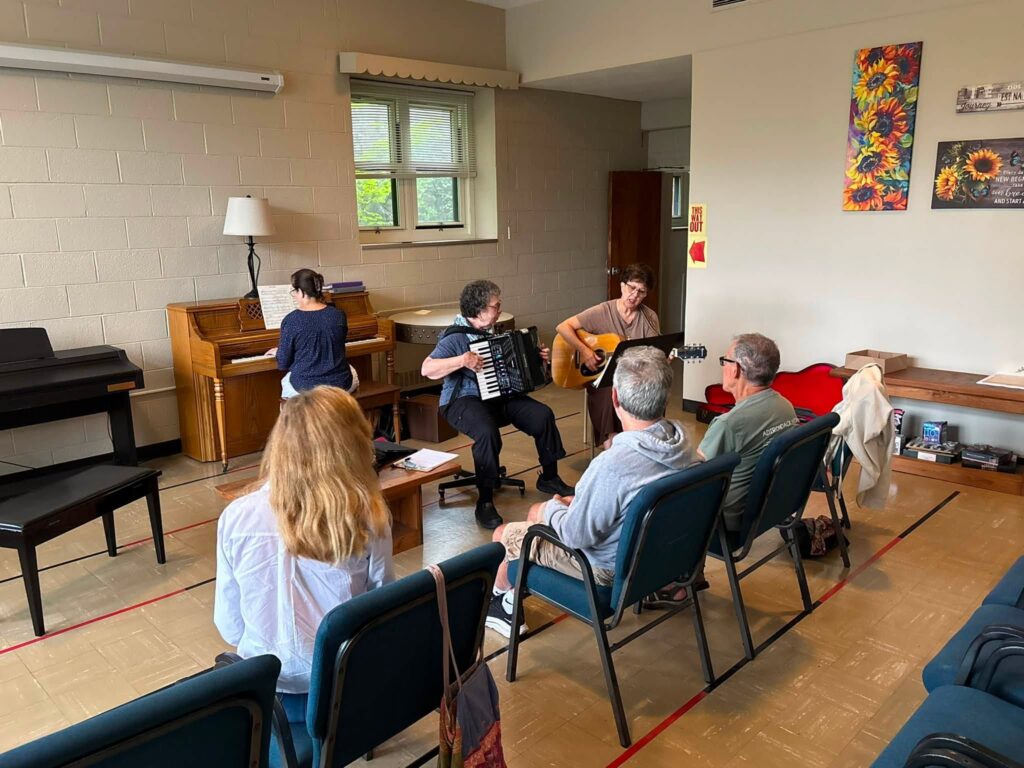 Concetta “Connie” Tomaino (left) plays the accordion, and volunteers lead sing-alongs during a session of Music and Memory at Holy Mountain at Graymoor in Garrison, September 2026.