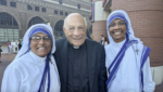Msgr. Hilary Franco (center) stands with two Sisters of Charity outside The Dome at America's Center in St. Louis on Sept. 24, 2026.