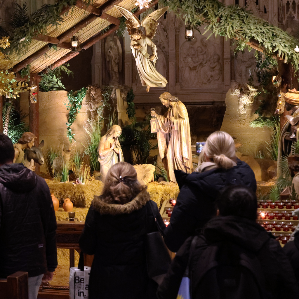 A crowd forms to view the beautiful Nativity creche.