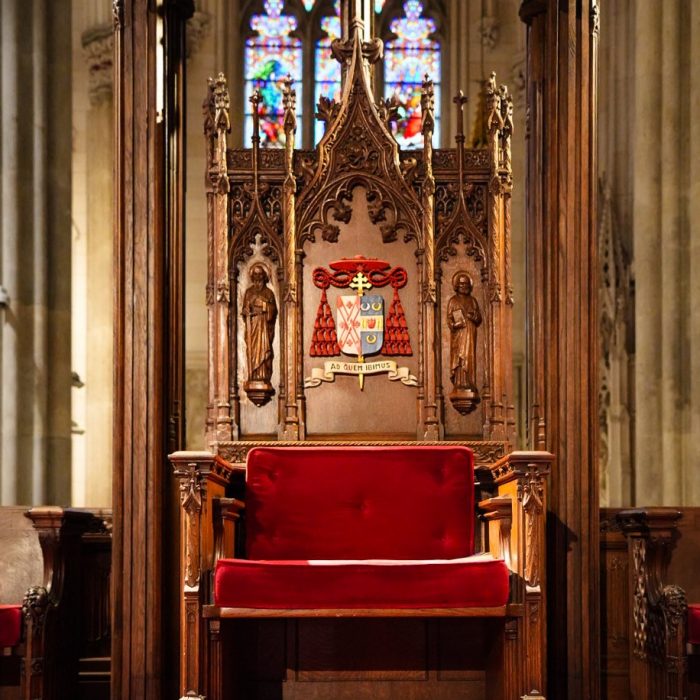 The cathedra near the high altar at St. Patrick's Cathedral features the coat of arms of Cardinal Timothy M. Dolan, symbolizing the teaching authority of the Archbishop of New York.