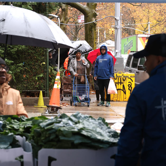 The beginning of the line waits for the distribution to begin as volunteers prepare.