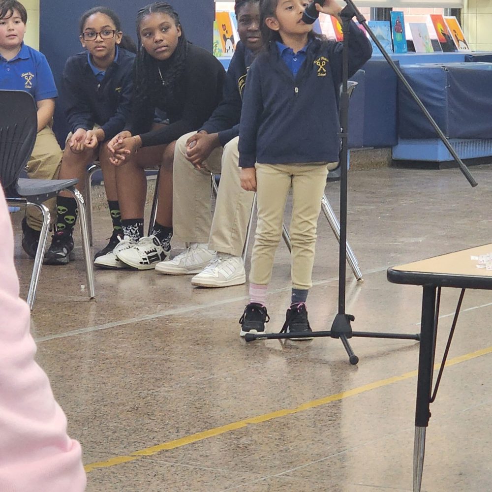 A student confidently answers the question directly into the microphone.