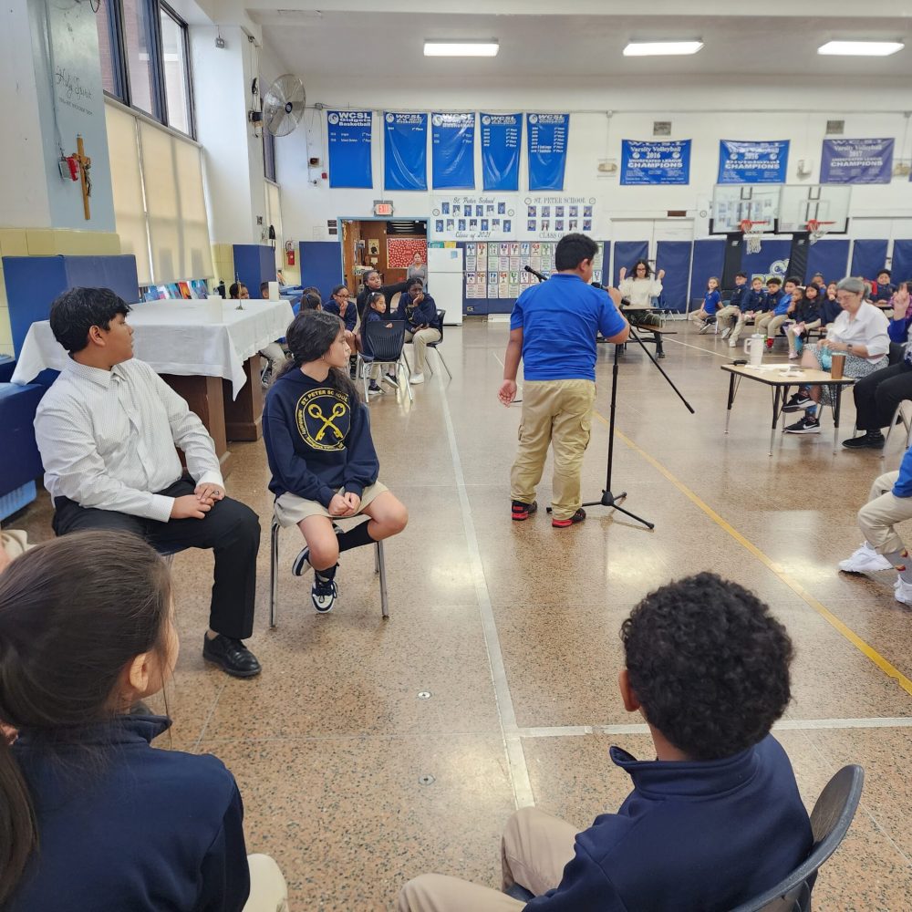 A student approaches the microphone as the rest of his team awaits the judge's decision