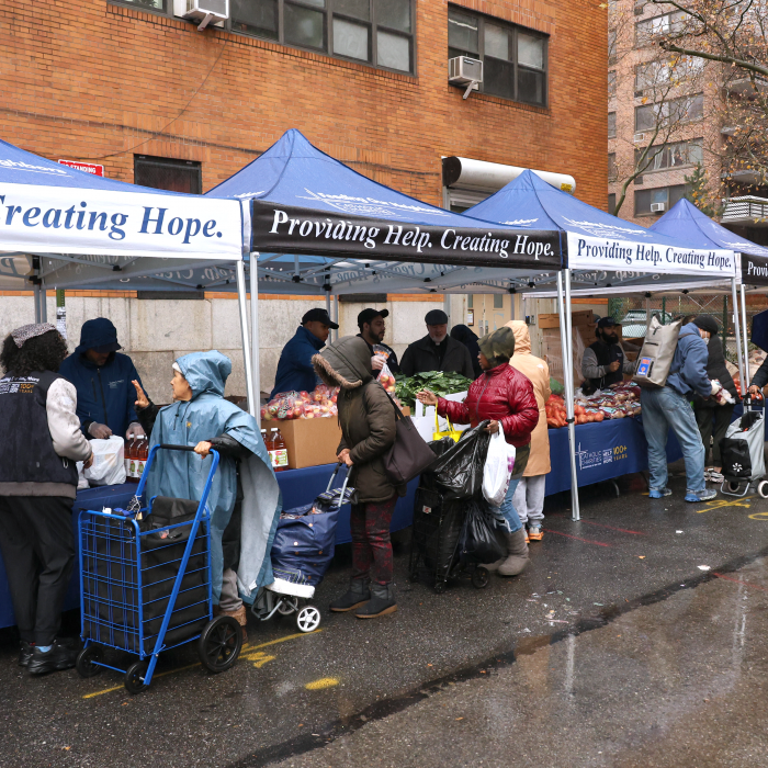 Clients make their way through the turkey distribution line with the help of Catholic Charities volunteers.