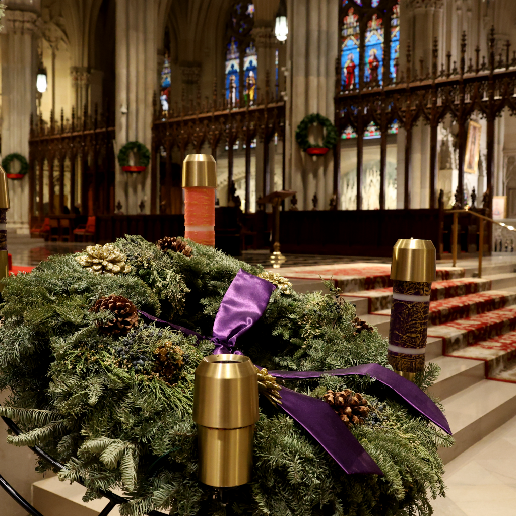 The Advent wreaths sits at the front of the altar.