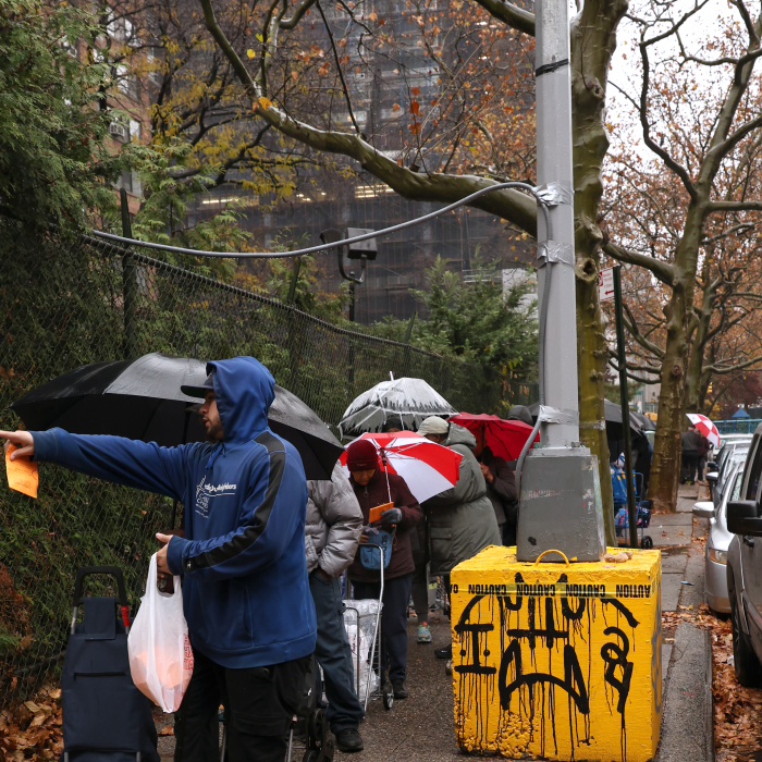 Here, you can see the line going all the way to the end of the street as a volunteer directs the next in line to the grocery pickup location.