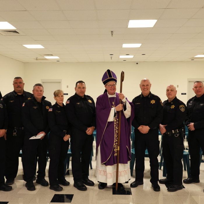 Cardinal Dolan poses with some of the officers in attendance.