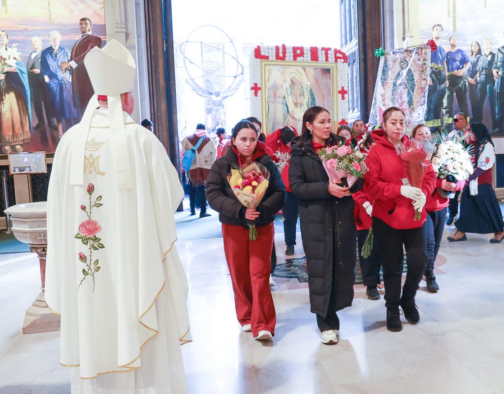 Archdiocese of New York Auxiliary Bishop Edmund Whalen (left) greets the procession for Our Lady of Guadalupe as it enters Saint Patrick’s Cathedral. Photo by Joe Vericker/Photobureau
