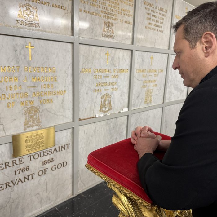 fr. salvo praying at tomb